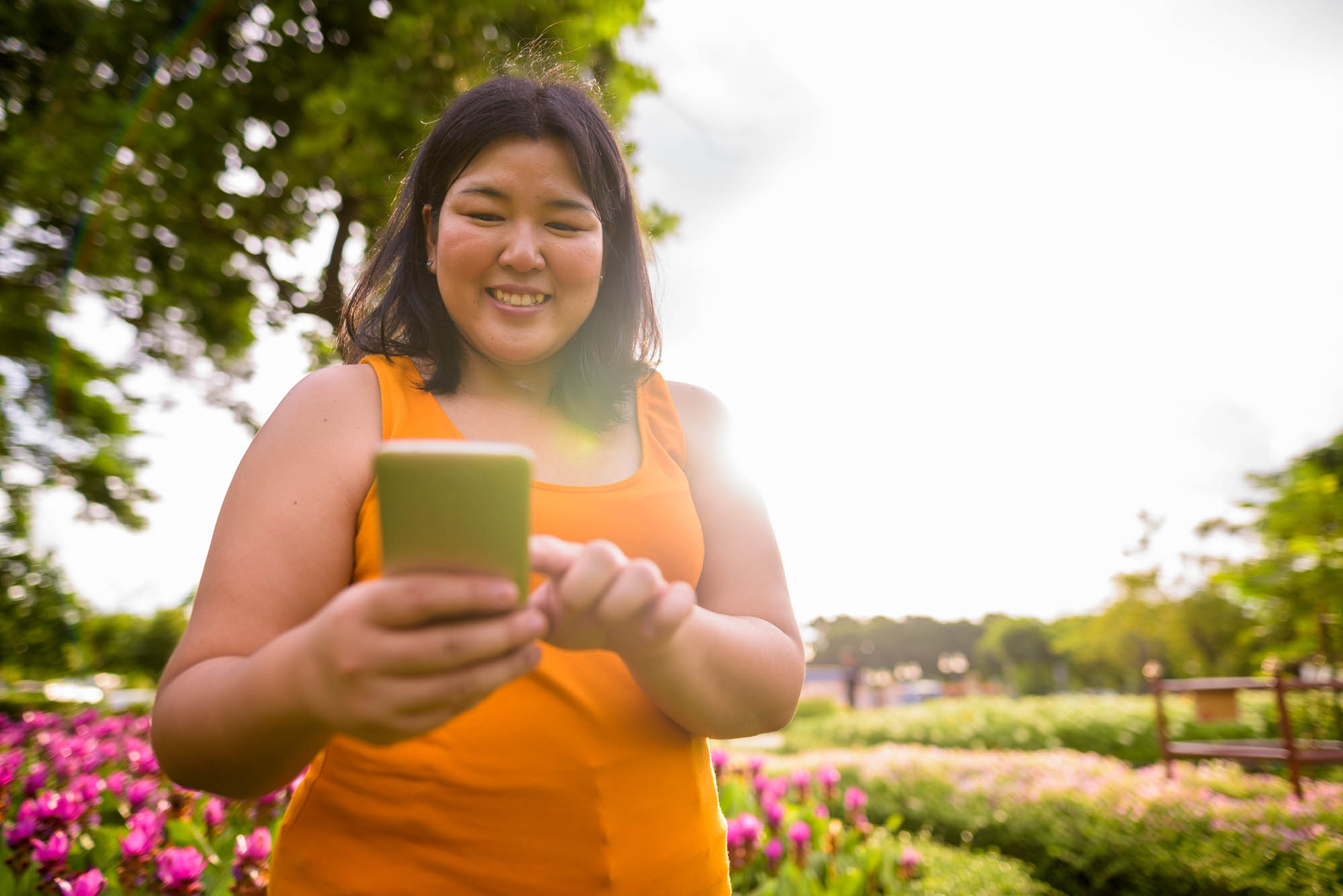 woman smiling on a walk and looking up "quick cash for test strip" on her phones